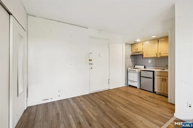a kitchen with a refrigerator and window