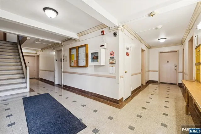 a large white room with wooden floor and white walls