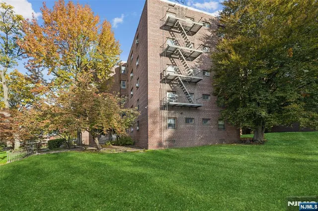front view of a house with a tree