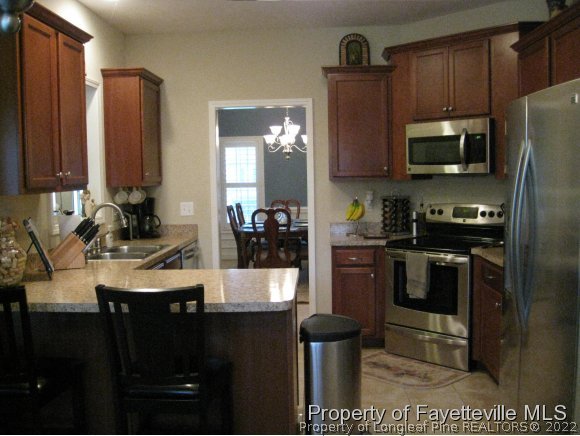 49 Germantown Road Cameron, NC 28326 - Photo 11 of 25 a kitchen with stainless steel appliances granite countertop a refrigerator a stove top oven a sink and dishwasher