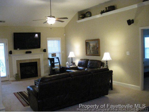 49 Germantown Road Cameron, NC 28326 - Photo 13 of 25 a living room with furniture a flat screen tv and a fireplace