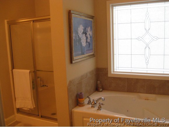49 Germantown Road Cameron, NC 28326 - Photo 18 of 25 a bathroom with a bathtub and a window
