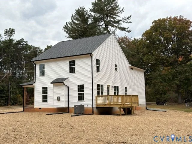 a view of a white house with a yard covered in snow
