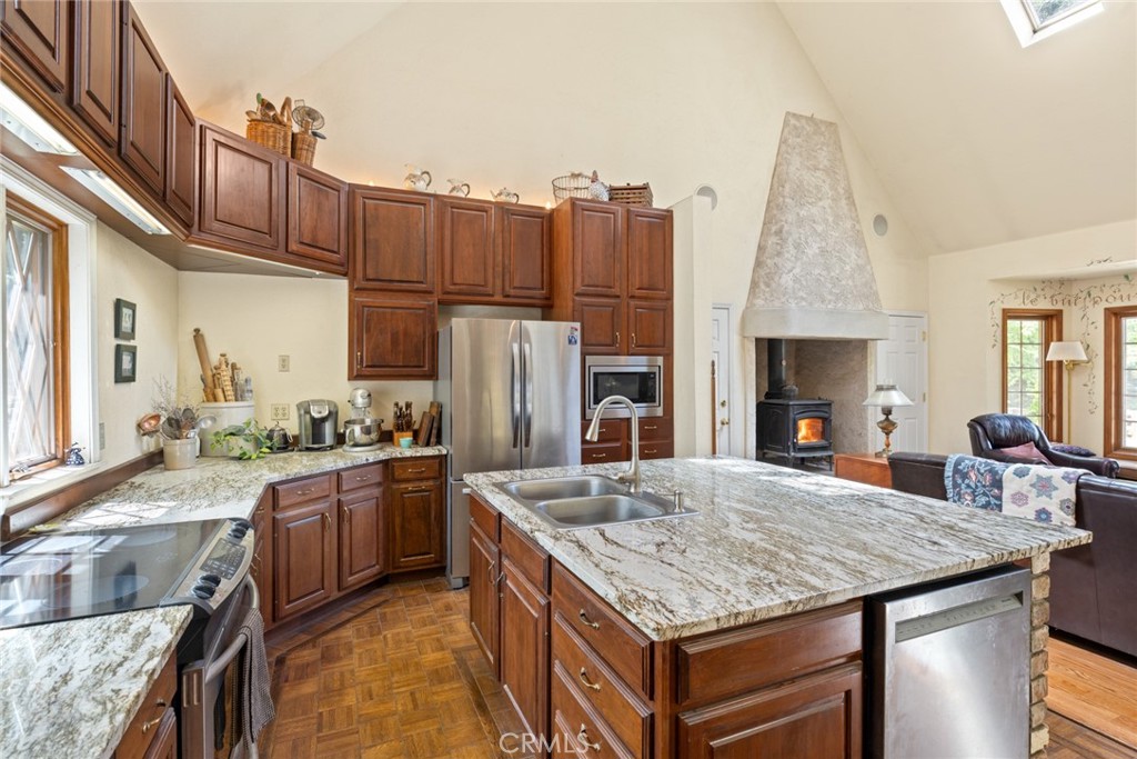 5555 Platt Mountain Road Forest Ranch, CA 95942 - Photo 14 of 55 a kitchen with kitchen island granite countertop a sink stove and refrigerator