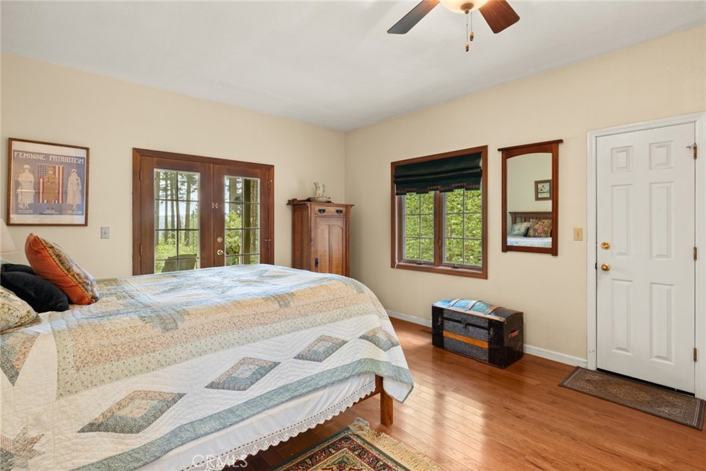 5555 Platt Mountain Road Forest Ranch, CA 95942 - Photo 27 of 55 a bedroom with a bed and a chandelier