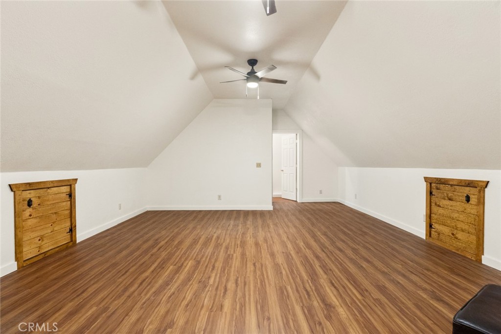 5555 Platt Mountain Road Forest Ranch, CA 95942 - Photo 32 of 55 an empty room with wooden floor fan and windows