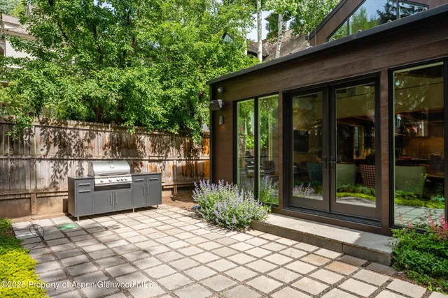 a backyard of a house with barbeque oven