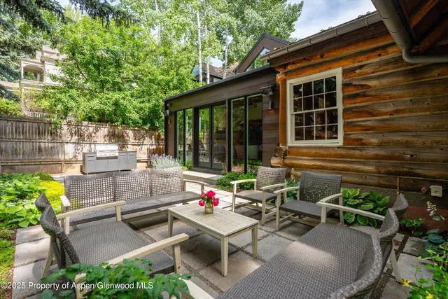 a view of backyard with outdoor seating and green space