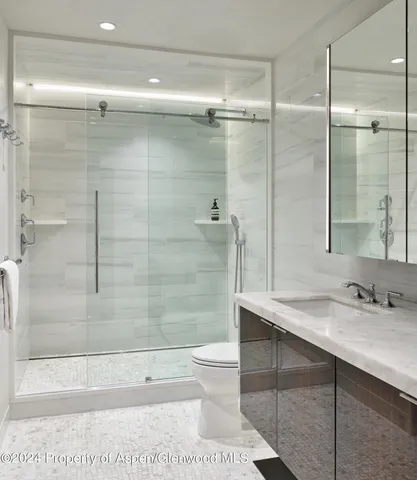 a bathroom with a sink toilet and shower