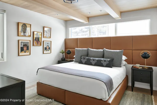 a bedroom with a bed and a night stand