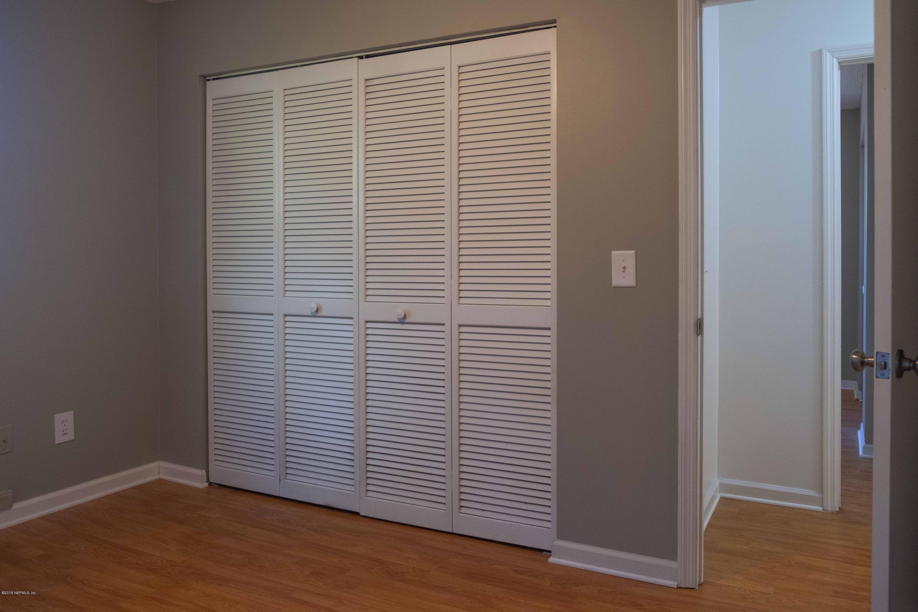133 Shamrock Road St. Augustine, FL 32086 - Photo 23 of 31 an empty room with wooden floor and a window