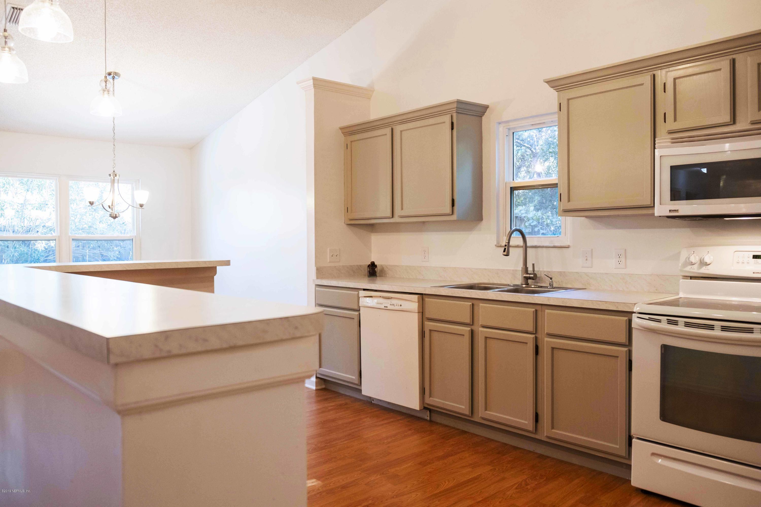 133 Shamrock Road St. Augustine, FL 32086 - Photo 10 of 31 a kitchen with a sink cabinets and microwave