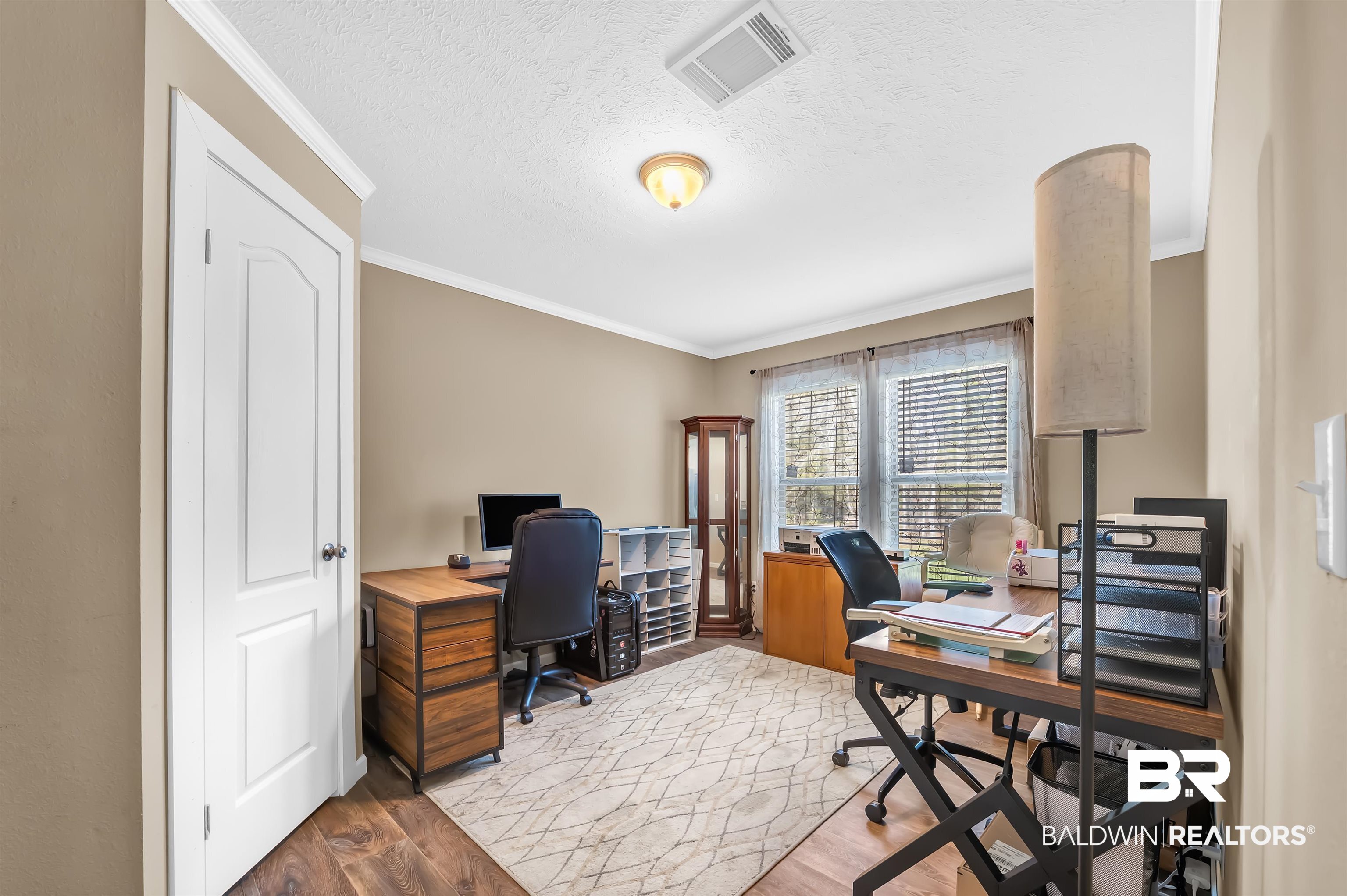 23233 Forland Road Silverhill, AL 36576 - Photo 24 of 33 Office space with visible vents, crown molding, wood finished floors, and a textured ceiling