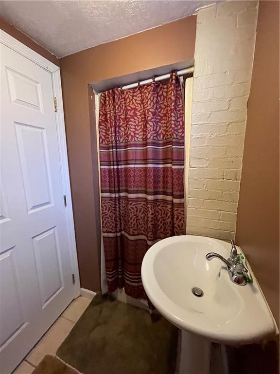321 Elm Road Ambridge, PA 15003 - Photo 22 of 25 a bathroom with a sink and shower