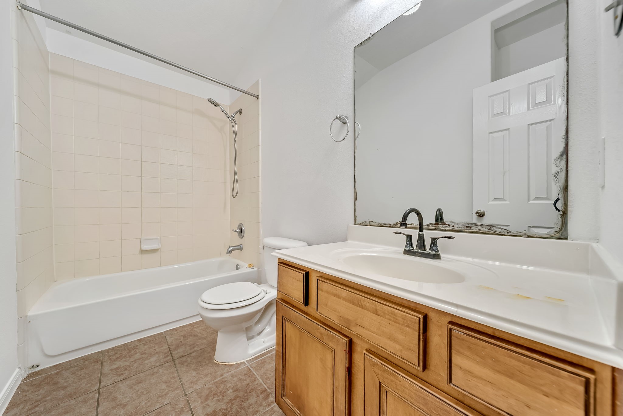 23526 Whispering Maple Drive Spring, TX 77373 - Photo 24 of 26 a bathroom with a sink a toilet and a large mirror