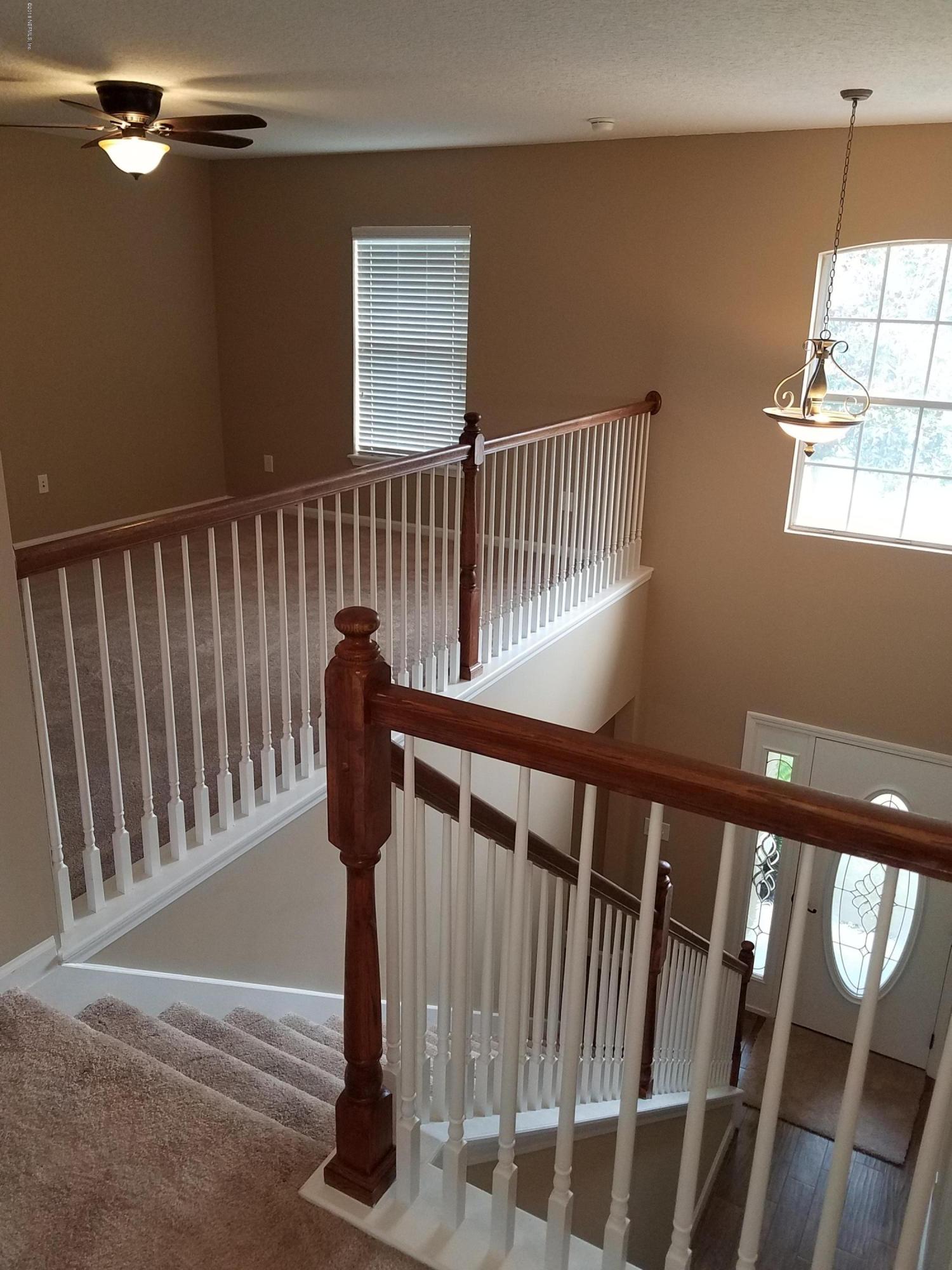 920 Silver Spring Court St. Augustine, FL 32092 - Photo 6 of 24 staircase at landing looking down to foy
