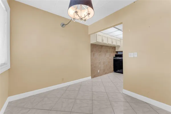 a kitchen with granite countertop a stove a sink and a refrigerator