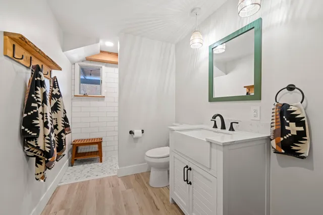 a bathroom with a sink a toilet and a mirror