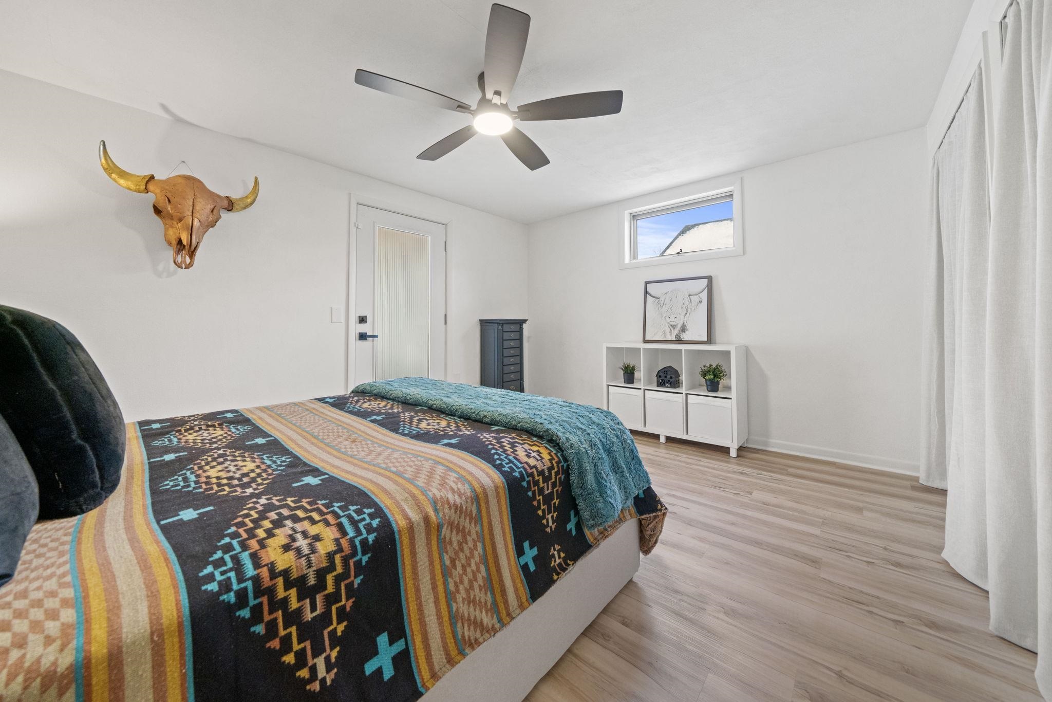 804 Jackson Street Oregon, IL 61061 - Photo 36 of 44 a bedroom with a large bed and a chandelier