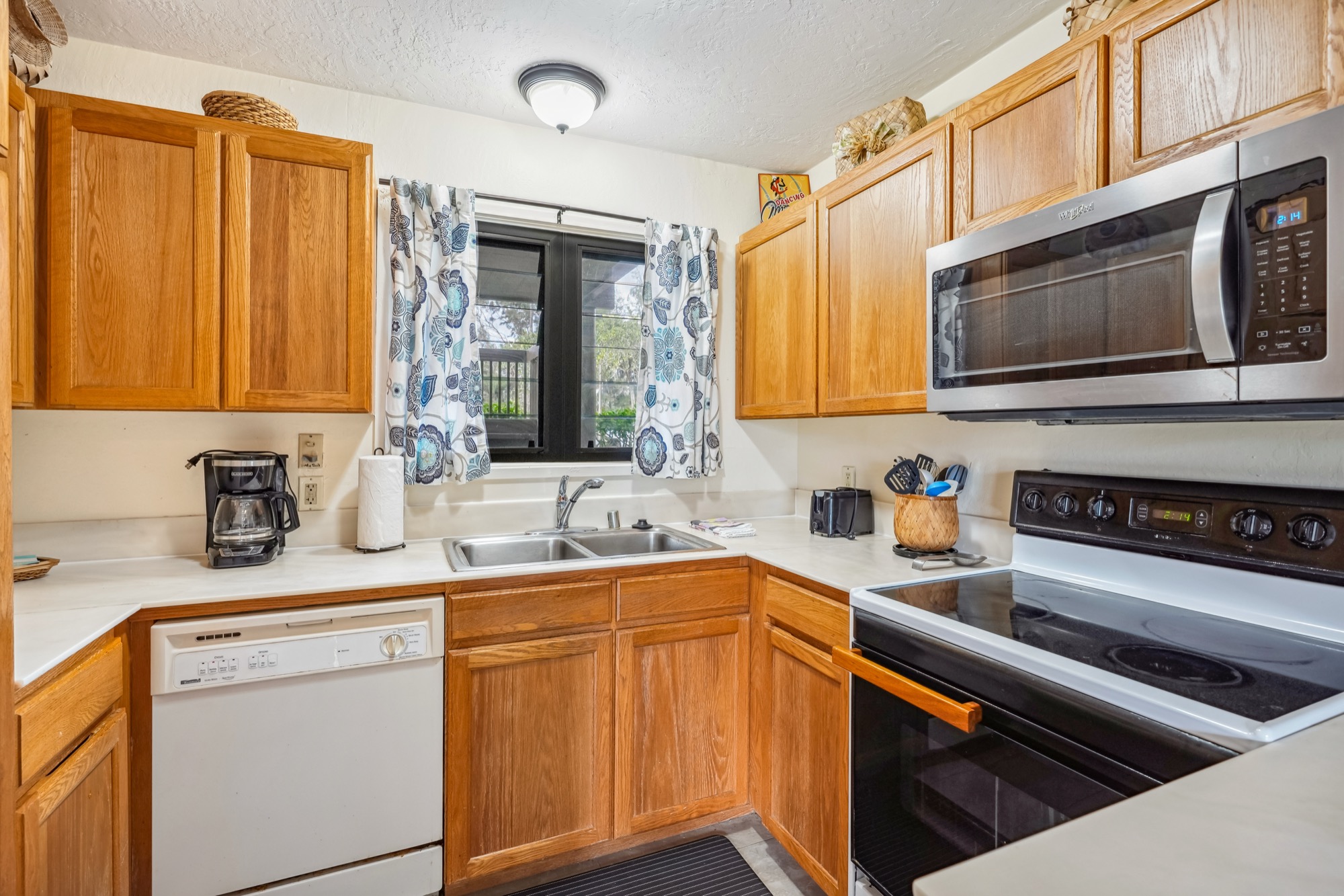 4460 Nehe Road, Unit 116 Lihue, HI 96766 - Photo 11 of 28 a kitchen with stainless steel appliances granite countertop a sink stove and cabinets