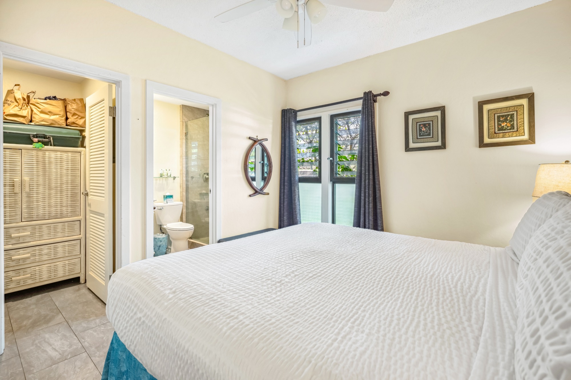 4460 Nehe Road, Unit 116 Lihue, HI 96766 - Photo 14 of 28 a bedroom with a large bed and a window