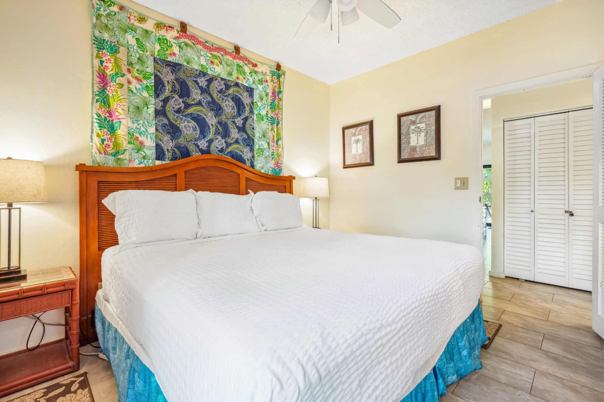 4460 Nehe Road, Unit 116 Lihue, HI 96766 - Photo 15 of 28 a bedroom with a bed and a painting on the wall