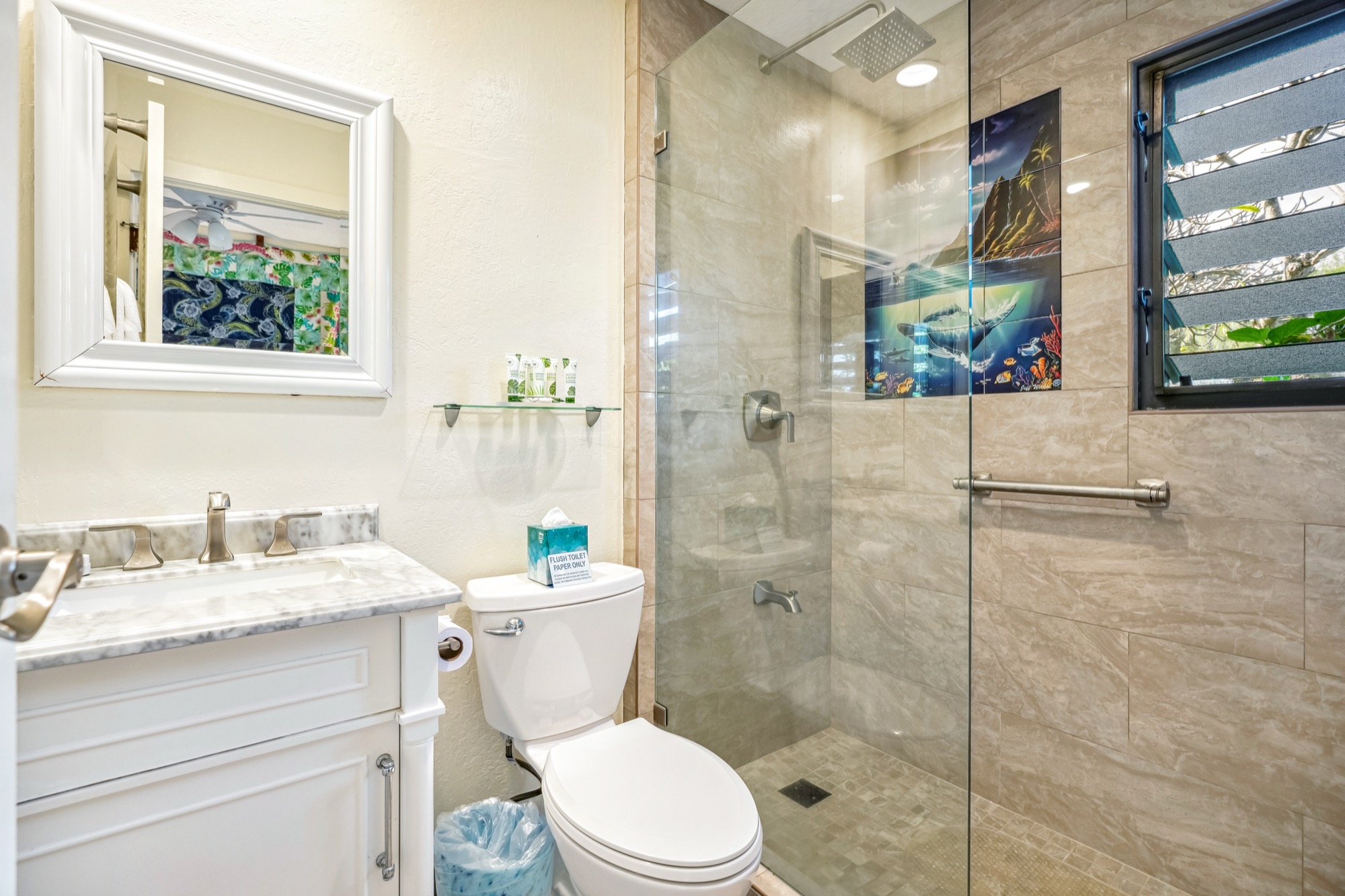 4460 Nehe Road, Unit 116 Lihue, HI 96766 - Photo 16 of 28 a bathroom with a granite countertop toilet a sink a mirror and a shower
