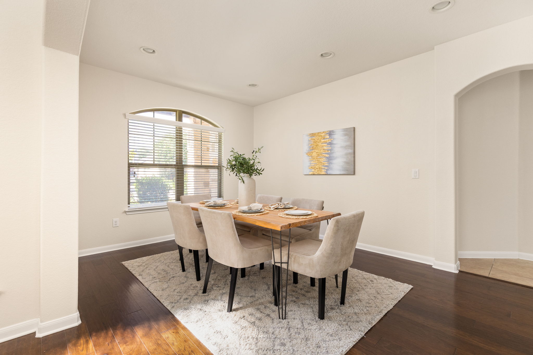 2400 Leonards Pass Leander, TX 78641 - Photo 2 of 40 Hardwood floors and recessed lighting elevate this inviting dining area, ideal for entertaining guests.