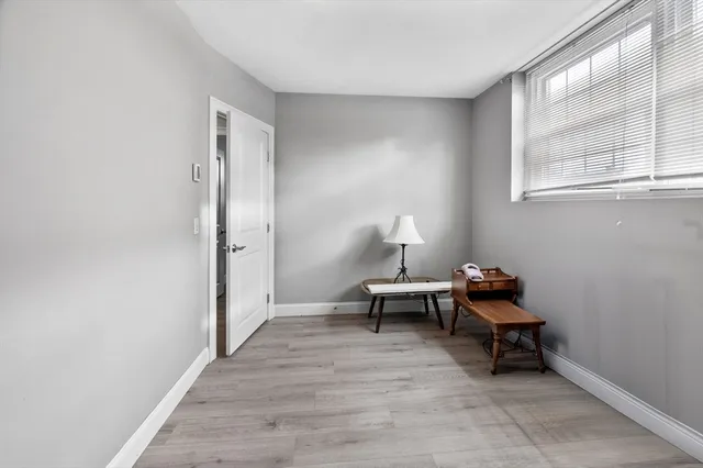 a view of a livingroom with wooden floor and furniture