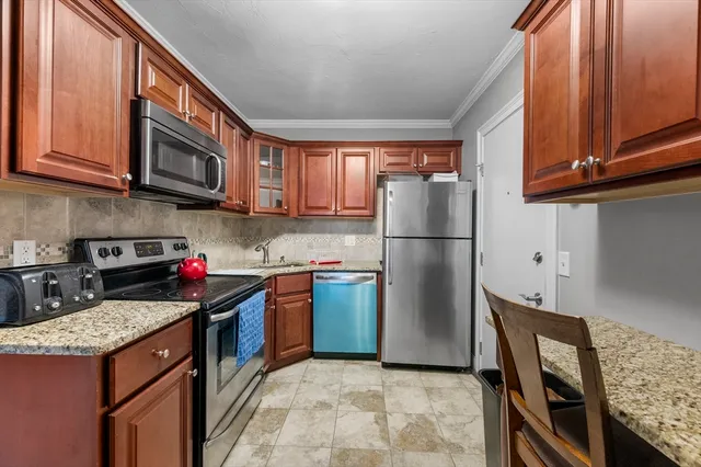 a kitchen with stainless steel appliances granite countertop a refrigerator stove and microwave