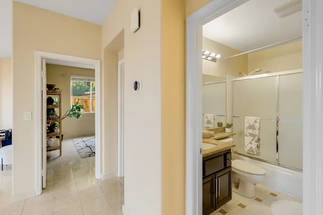 a kitchen with stainless steel appliances kitchen island granite countertop a refrigerator and a sink