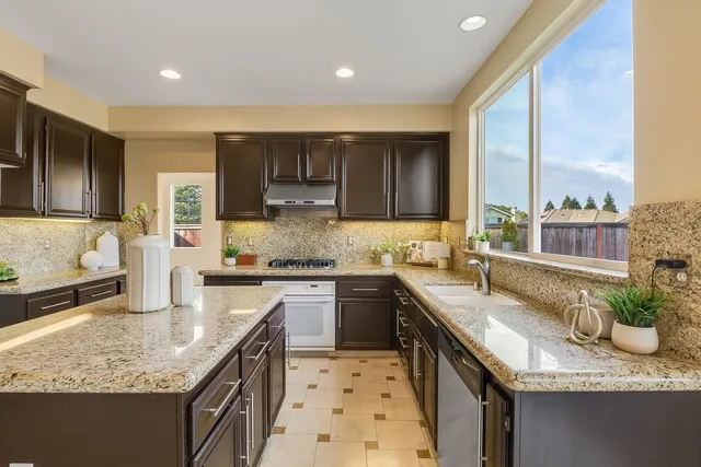 a living room with furniture kitchen and a chandelier