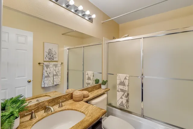 a bedroom with a bed and a potted plant