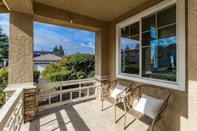 a balcony with table and chairs