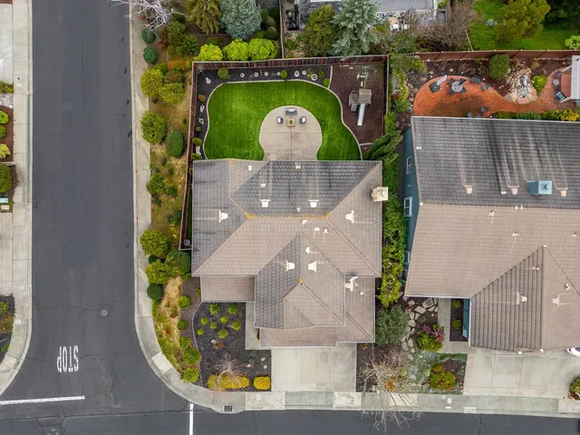 an aerial view of a house with a yard basket ball court