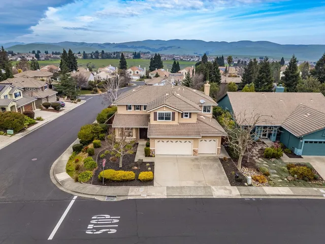 an aerial view of a house with a swimming pool yard and outdoor seating