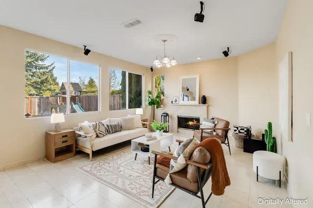a living room with furniture fireplace and a large window