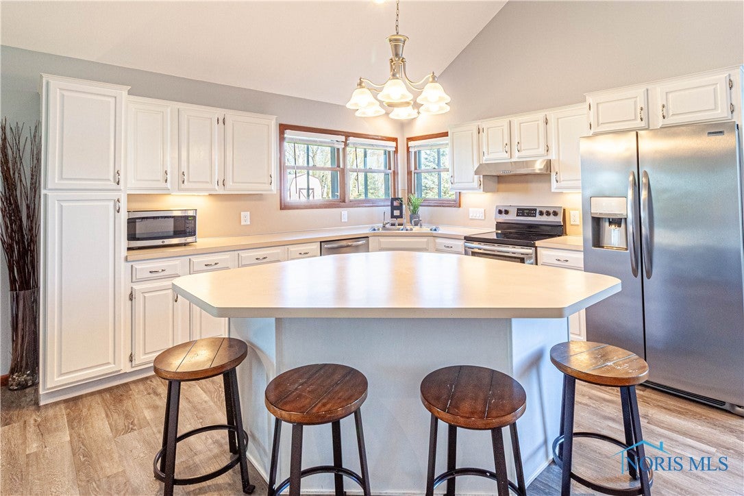 556 South Lathrop Road Swanton, OH 43558 - Photo 9 of 45 Large kitchen island for prep and plenty of cabinet space awaits.