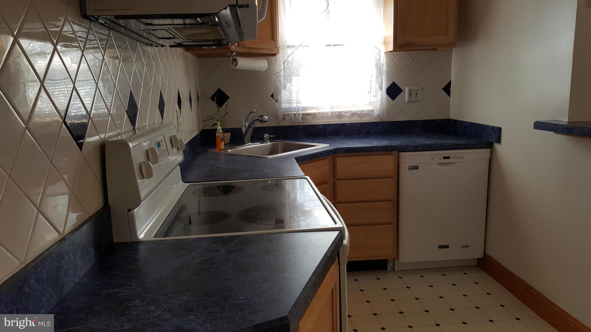 1943 Jasmine Road Baltimore, MD 21222 - Photo 4 of 29 a kitchen with a sink a refrigerator and window
