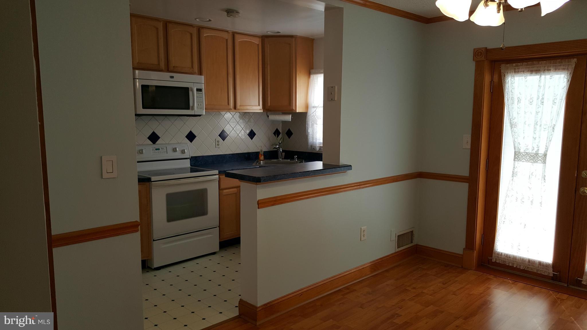 1943 Jasmine Road Baltimore, MD 21222 - Photo 5 of 29 a kitchen with a sink stove and microwave
