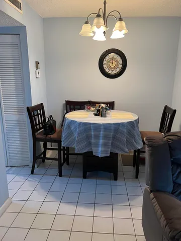 a view of a dining room with furniture and rug
