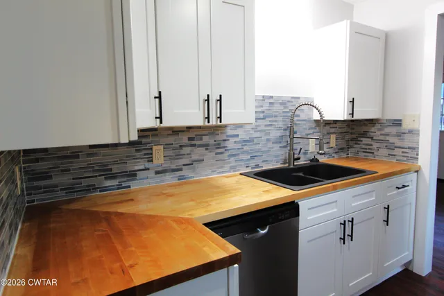 a kitchen with a sink and cabinets