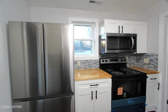 a kitchen with a stove microwave and refrigerator
