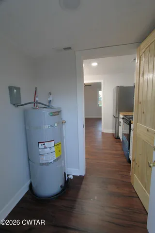 a view of a kitchen with appliances and wooden floor