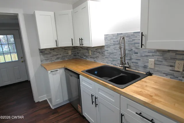 a kitchen that has a sink and a stove