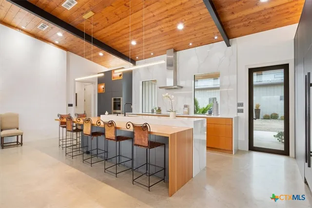 a bathroom with a sink a toilet a mirror and shower