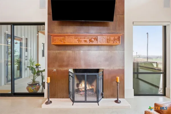 a living room with furniture and a floor to ceiling window