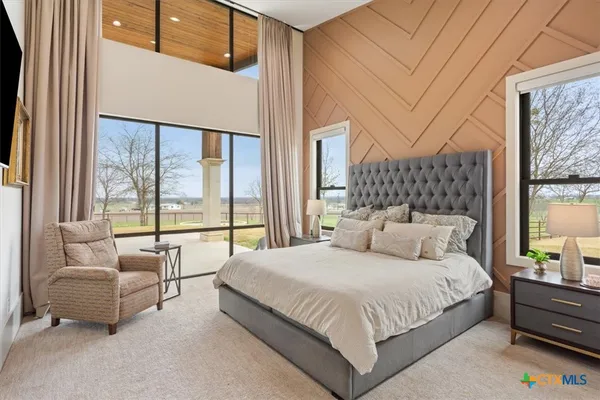 a bedroom with a large bed and a large window