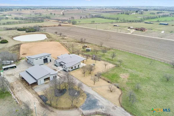an aerial view of a house with a big yard