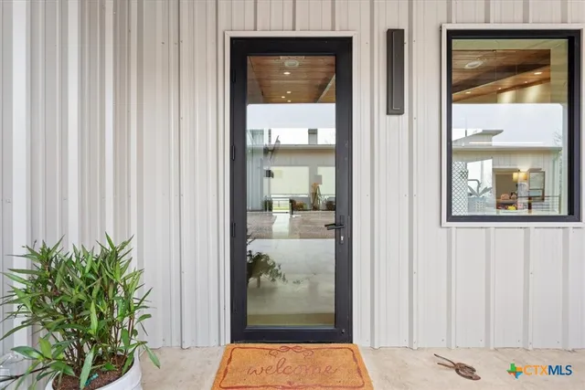 a living room with furniture and a floor to ceiling window